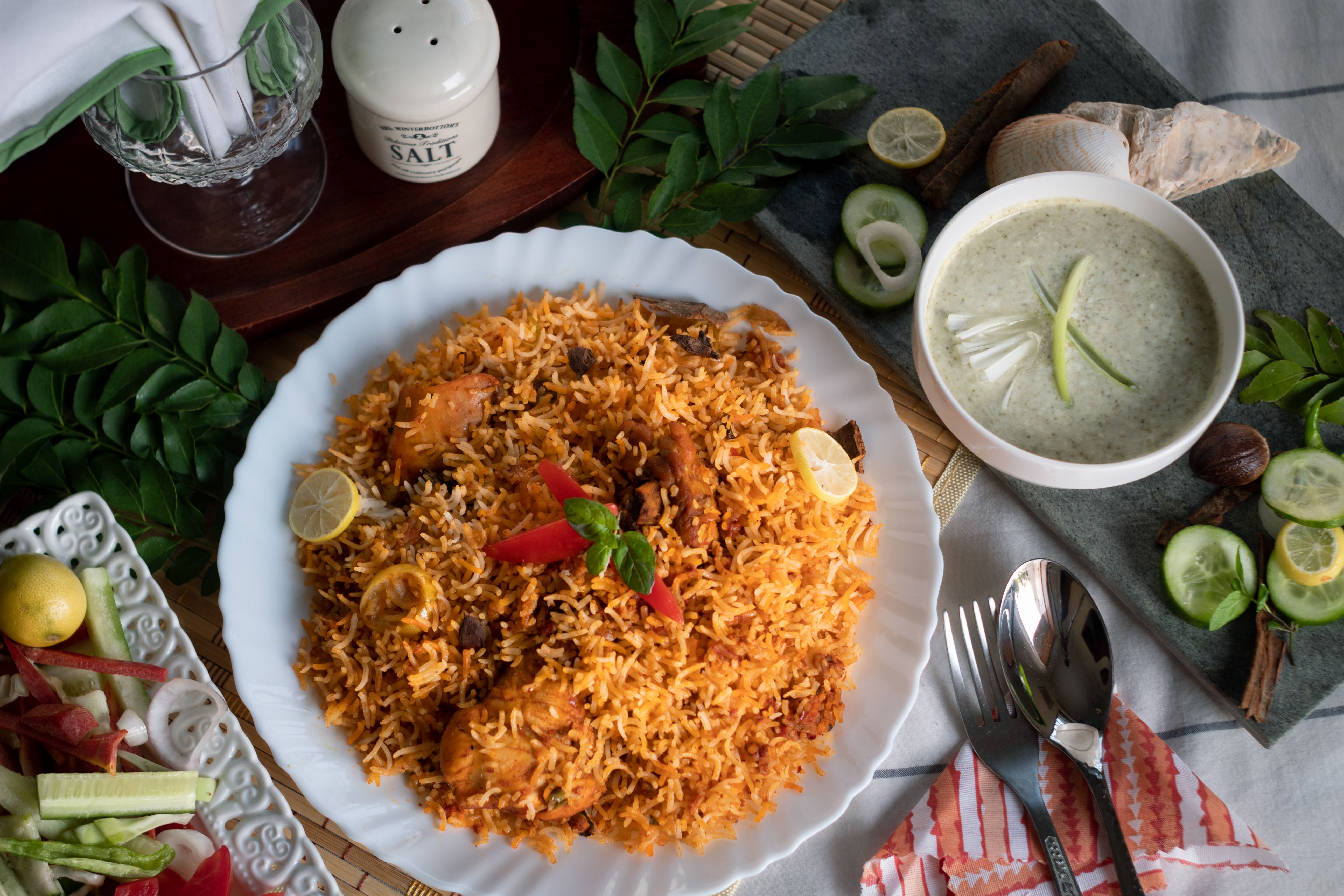 A traditional Pakistani biryani feast served on a large platter